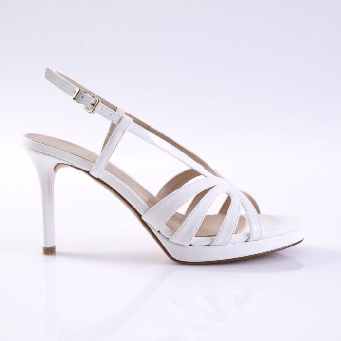 White strappy high-heeled sandal with an ankle buckle and slim stiletto heel on a white background.