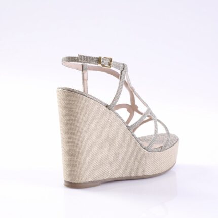 Beige glittery wedge sandal with ankle strap and gold buckle, displayed from the side on a white background