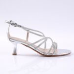 Silver strappy sandal with rhinestone-adorned bands and a short kitten heel, open toe, on a white background.