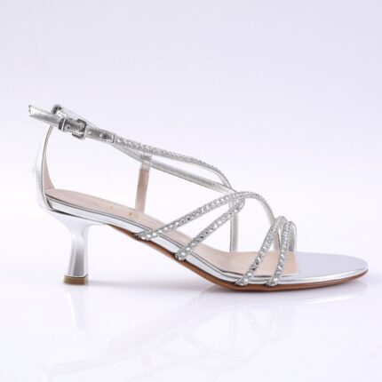 Silver strappy sandal with rhinestone-adorned bands and a short kitten heel, open toe, on a white background.