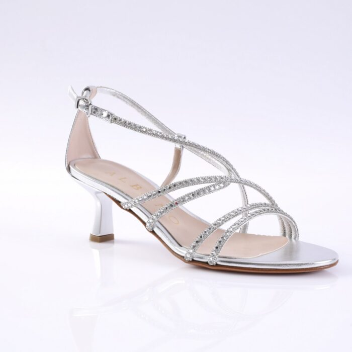 Silver women's sandal with rhinestone-embellished straps and a small heel on a white background.