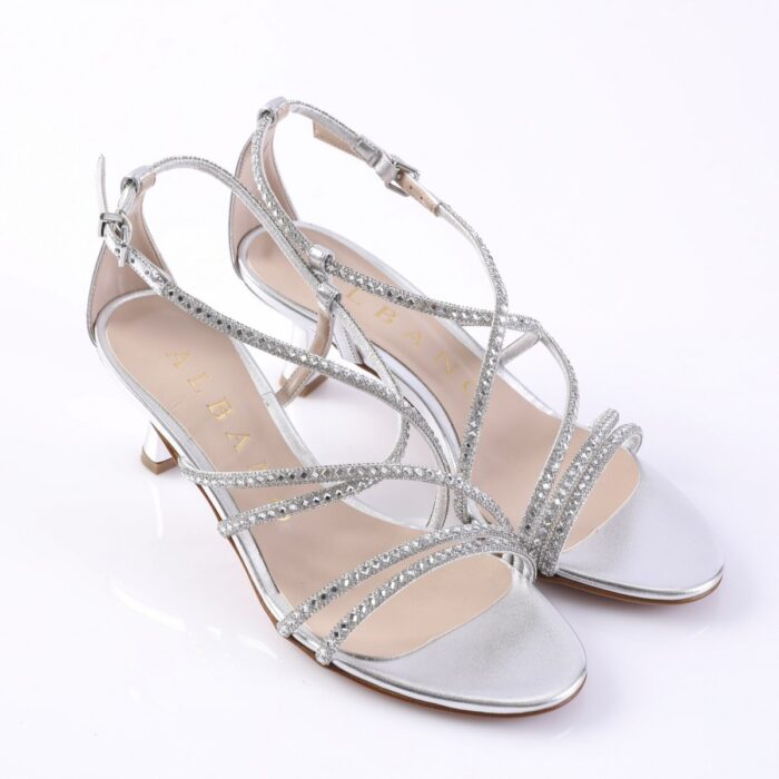 Silver strappy high-heeled sandals with rhinestone embellishments on a white background.