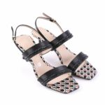 Open-toe black sandals with glittery straps and a patterned multicolor insole, shown from a side angle on a white background