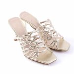 Gold metallic high-heeled sandals with an intricate lattice strap design and square toe, side view showing stiletto heels