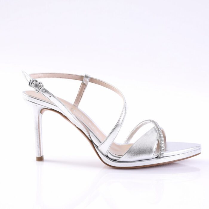 Silver metallic high-heeled sandal with an ankle strap and jeweled toe band on a white background.