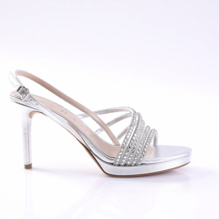 Silver strappy high-heeled sandal with rhinestone bands and an ankle buckle.