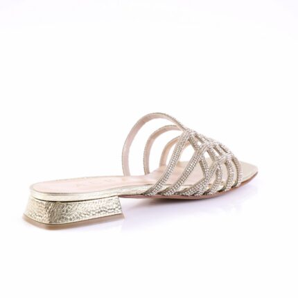 Silver strappy sandal with rhinestone-studded straps and a low textured heel in metallic finish.