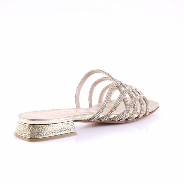 Silver strappy sandal with rhinestone-studded straps and a low textured heel in metallic finish.