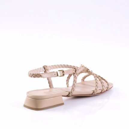 Beige braided-strap sandal with ankle buckle and low block heel, shown from a side angle