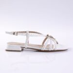 White braided-strap sandal with ankle strap and rhinestone embellishment, low block heel visible from the side.