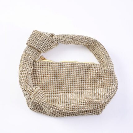 Gold-toned handbag encrusted with rhinestones and a twisted handle for a sparkling evening look.