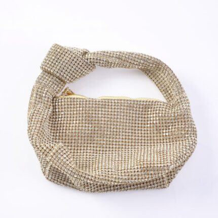 Gold crystal-embellished handbag with a knotted, bejeweled strap and zipper closure