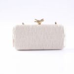 White rectangular clutch bag with a vertical ribbed texture and a gold knotted clasp at the top center