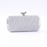 Silver textured clutch purse with a metallic knot clasp on a white background, front view