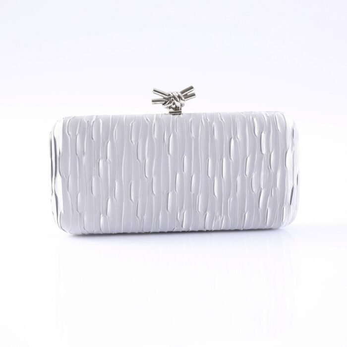Silver textured clutch purse with a metallic knot clasp on a white background, front view