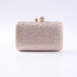 Rose-gold clutch purse covered in rhinestones with a jeweled kiss-lock clasp on top.