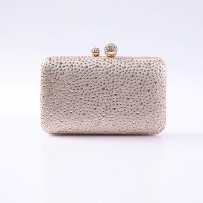 Rose-gold clutch purse covered in rhinestones with a jeweled kiss-lock clasp on top.