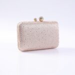 Beige clutch purse covered in small rhinestones with a two-ball clasp on top.