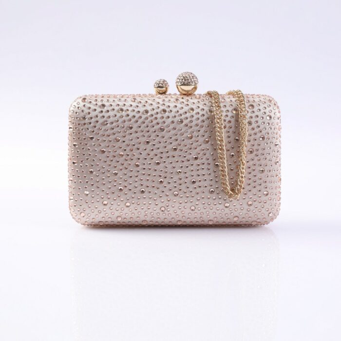 Beige rhinestone-covered clutch with a gold chain strap, posed against a white background for an evening bag look.