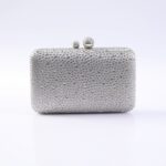 Silver clutch purse covered in small rhinestones with a two-ball clasp on top.