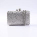 Silver evening clutch covered in tiny rhinestones with a round ball clasp and chain strap.