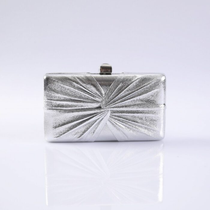 Silver metallic clutch purse with a radial, pleated pattern on a white reflective surface.