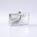 Silver rectangular clutch purse with a textured, starburst pattern and a small clasp on top.
