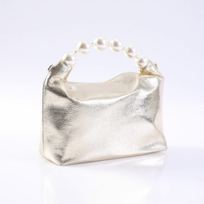 Gold metallic clutch purse with a pearl bead handle on a white surface.