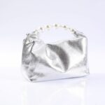 Silver metallic clutch purse with a pearl bead handle on a white background.