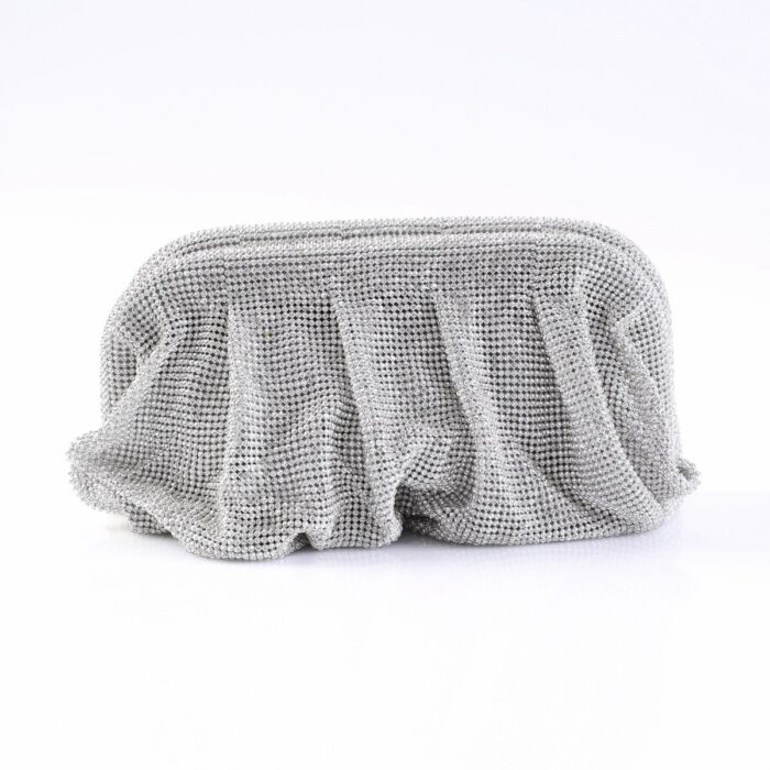 Silver beaded clutch bag on a white surface, reflecting light from many tiny studs.