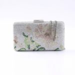 Silver beaded clutch with a subtle floral pattern and a short silver chain strap.