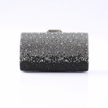 Beaded gradient evening clutch bag from silver to black, resting on a white surface.