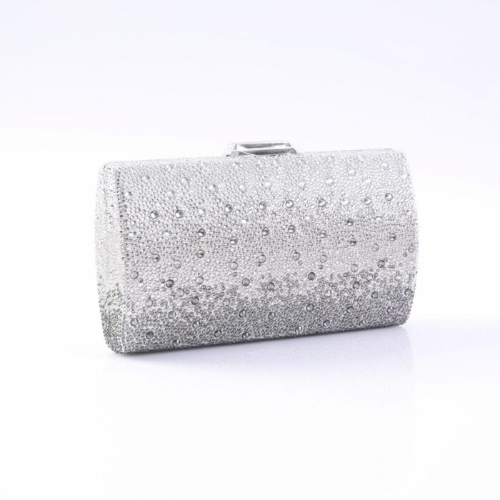 Silver clutch purse encrusted with rhinestones on a white surface, with a small clasp on top.