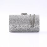 Silver rhinestone-covered clutch bag with a silver chain strap, photographed against a white background