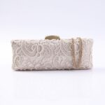 Beige lace clutch bag with a gold-tone frame and chain strap.