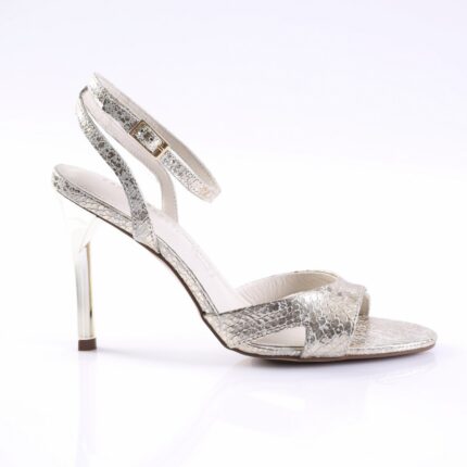 Silver snakeskin‑patterned high-heeled sandal with ankle strap and gold buckle, clear stiletto heel, for a product photo