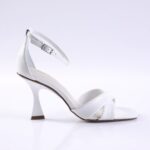 White strappy high-heeled sandal with an ankle strap and curved heel on a clean white background.