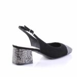 Black suede slingback pump with a low, chunky metallic-embossed heel and ankle strap.
