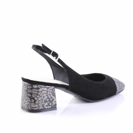 Black suede slingback pump with a low, chunky metallic-embossed heel and ankle strap.