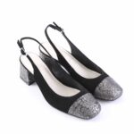 Black slingback pumps with metal-patterned silver toe caps and a low block heel on a white background, women’s dress shoes