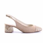 Beige suede slingback pump with a thin ankle strap and a small gold buckle; the heel and toe feature white embroidered detailing.