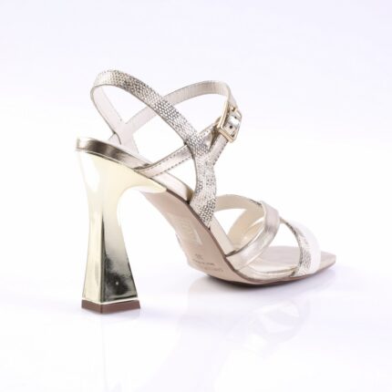 Silver metallic heeled sandal with crisscross straps and a textured ankle strap, open toe, and square heel silhouette.