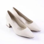 Pair of cream-colored women's pumps with a chunky striped block heel on a white surface.