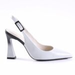 White pointed-toe slingback pump in white leather with a black square buckle and a geometric block heel.