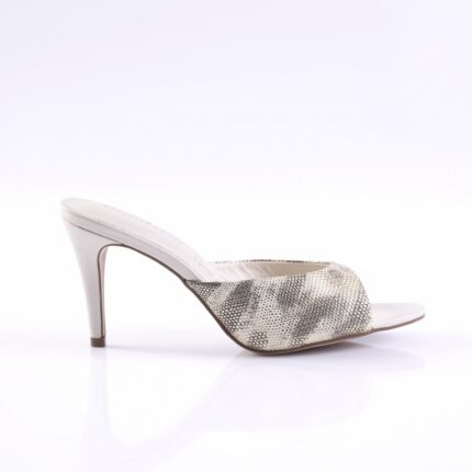 White open-toe mule with a snakeskin-pattern wide strap and a slim stiletto heel on a white studio surface
