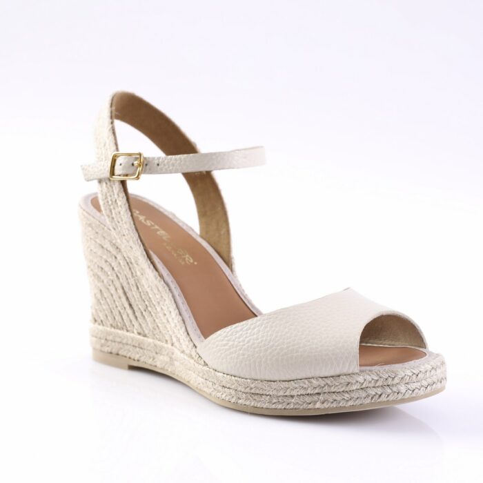 Cream espadrille wedge sandal with peep-toe and ankle strap featuring a gold buckle.