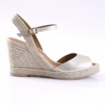 Silver wedge espadrille sandal with a braided jute heel and ankle strap buckle.