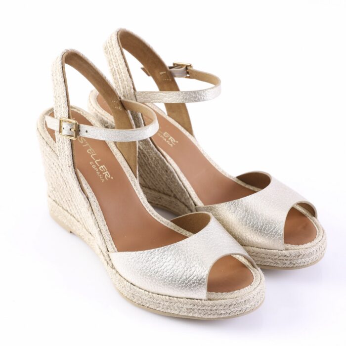 Gold metallic open-toe wedge sandals with ankle strap and braided espadrille sole.