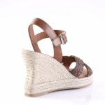 Brown leather ankle-strap wedge sandal with braidedJute espadrille sole; side view highlighting buckle strap and braided front straps