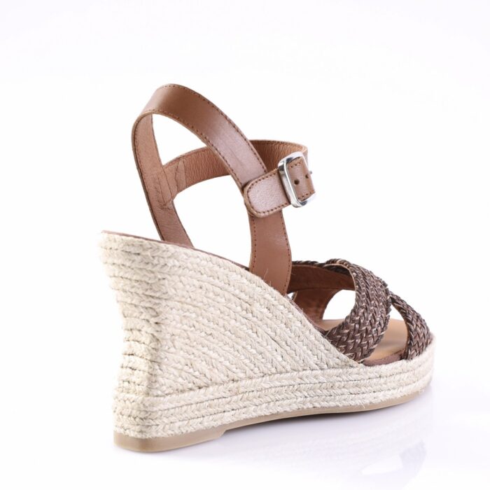 Brown leather ankle-strap wedge sandal with braidedJute espadrille sole; side view highlighting buckle strap and braided front straps